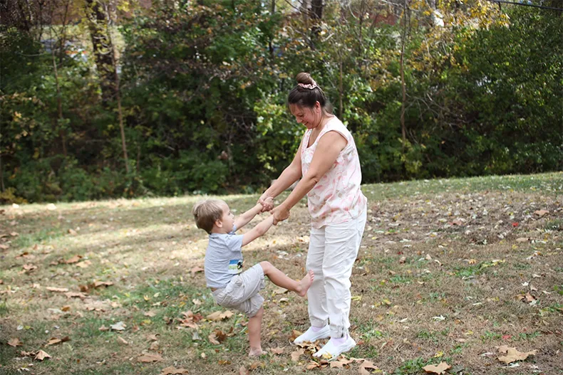 Esther Reddish-Hanner and her son, Alex, play in their backyard in De Soto.