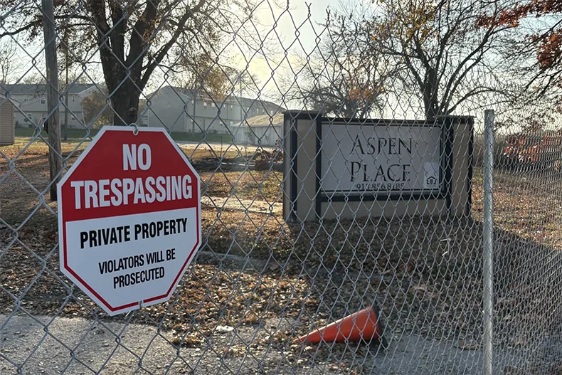 Temporary fences block the entryway to Aspen Place apartments. The City of Gardner condemned the housing complex for unsafe living conditions amid ongoing water and sewage issues.