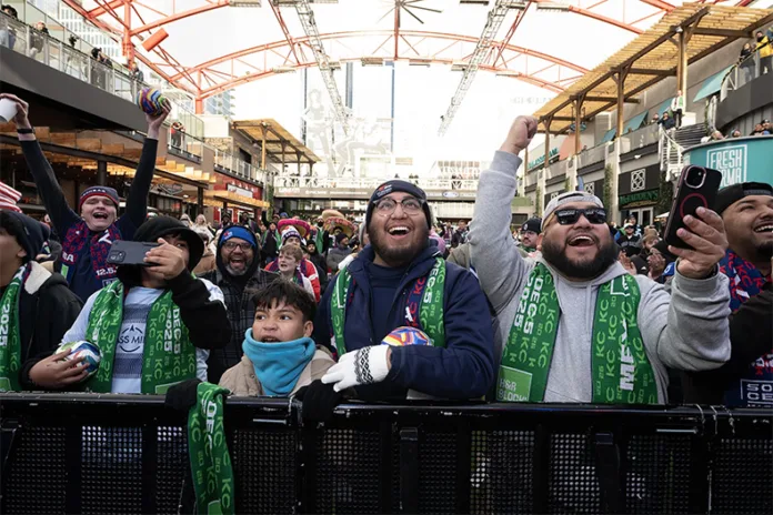 Young fan Eddy Reyes, from left, his father Juan Reyes, and Enrique Reyes cheer as the results begin to come in. In the countdown to the FIFA World Cup 26, a region-wide watch party for the FIFA World Cup 26 Final Draw drew a crowd of Friday morning to KC Live! in the Power & Light District.