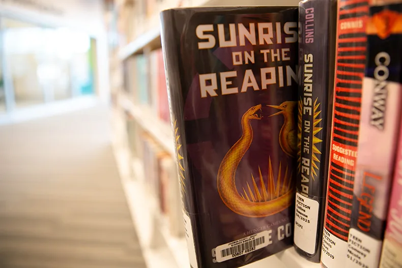 "Sunrise on the Reaping" by Suzanne Collins at the Merriam Plaza Library. Photo illustration by Juliana Garcia. 