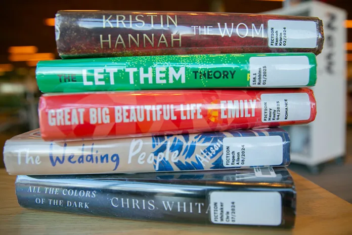 Johnson County Library's top five most-checked out books of 2025. Photo illustration by Juliana Garcia.
