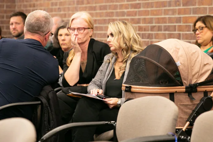 Toni Skelton sits next to her spider monkey, Oakley, in Prairie Village council chambers.