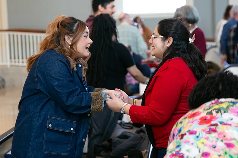 Prompted by a word of welcome from Rev. Dr. Rodger Nishioka, attendees wished each other peace at the beginning of the event. Photo credit Juliana Garcia. 
