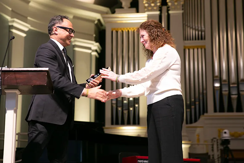 Dr. George Williams, president of Stand Up for Black Lives+ Prairie Village, hands an award to Mary Wirken for her efforts to advance diversity, equity and inclusion in Prairie Village. Two others also got awards from Williams. Photo credit Juliana Garcia. 