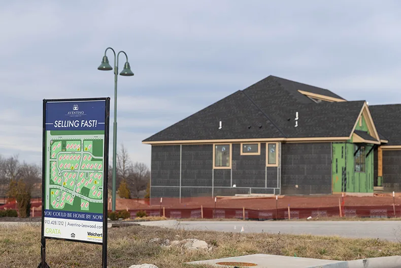A sign advertising new homes for sale at the Aventino at Leawood housing development.