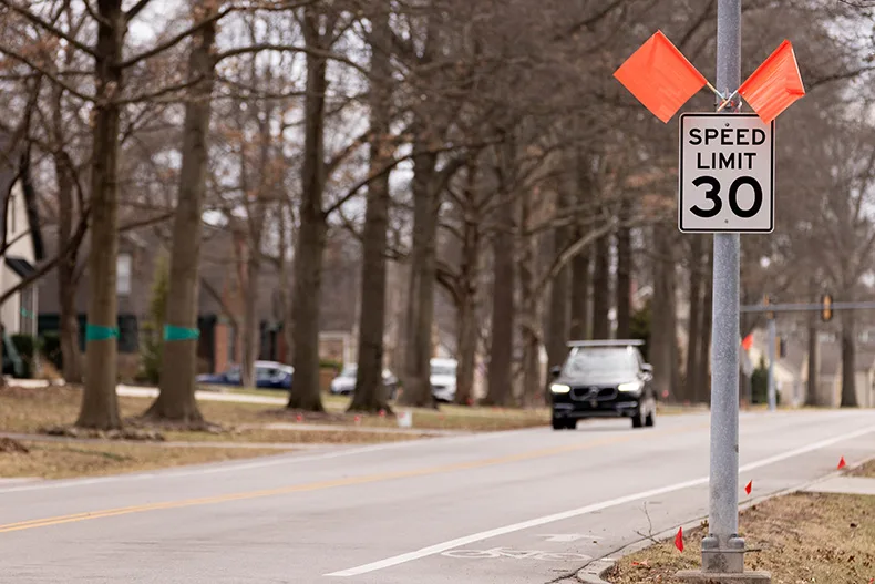 A car drives past a new speed limit sign posted on Lee Boulevard on Tuesday, Feb. 24, in Leawood.