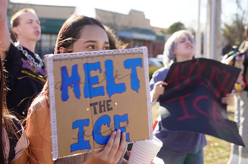 A woman holds a sign that says "MELT THE ICE"