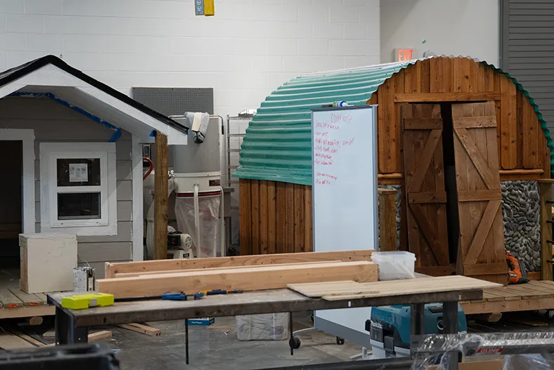 Two playhouses in a workshop. 