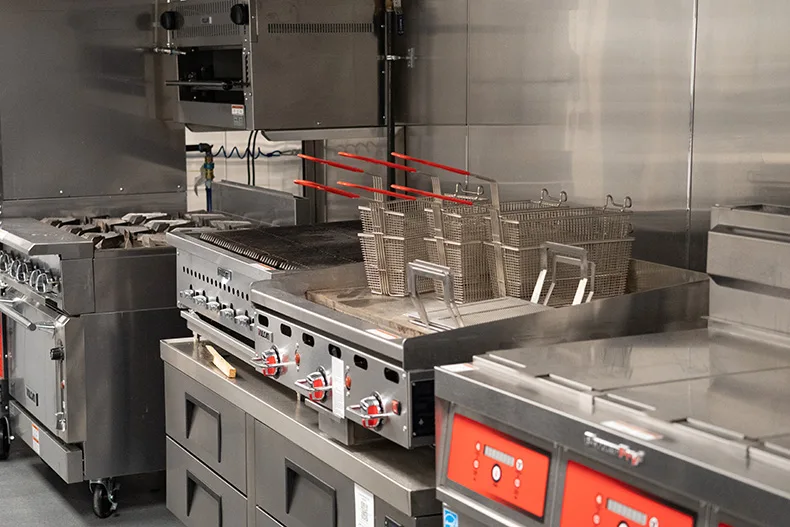 An industrial kitchen with a fryer. 