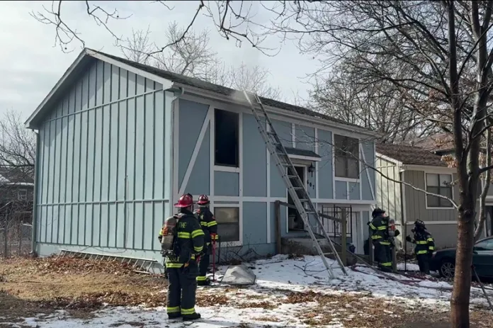 Firefighters work to bring a house fire under control in Olathe on Tuesday.
