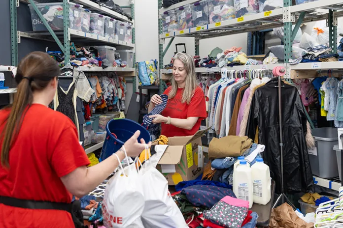 Volunteer Natalie Smith folds and sorts clothes donated to the Starfish Project.