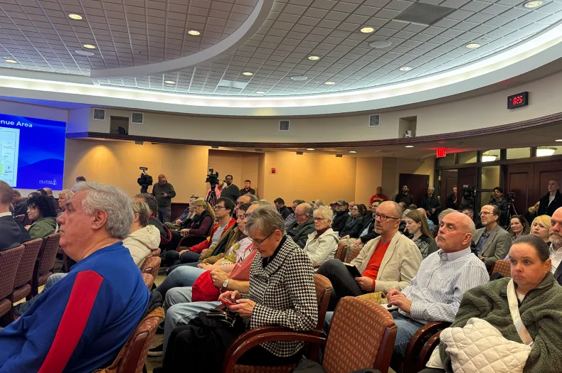 People sit in room.
