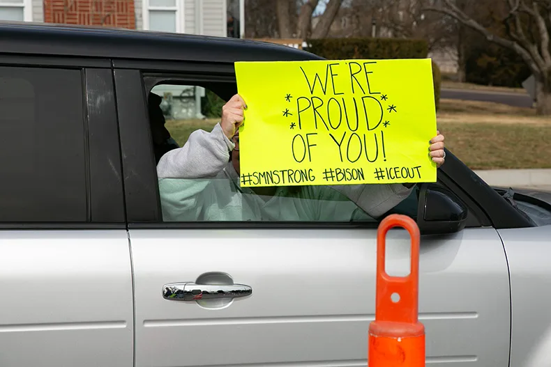 A parent drives by the SM North ICE protest with a sign that read "We're proud of you!" Photo credit Juliana Garcia.