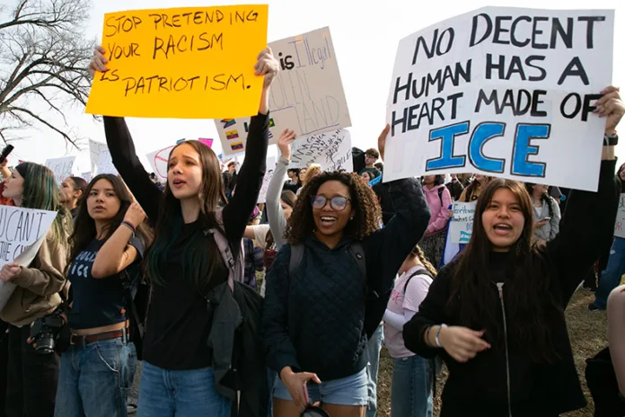 Students stand on the front lawn of SM North to protest ICE. Photo credit Juliana Garcia.
