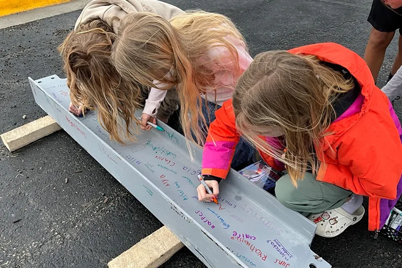 Students at Timber Sage Elementary School got the chance to sign beams before construction crews installed them.
