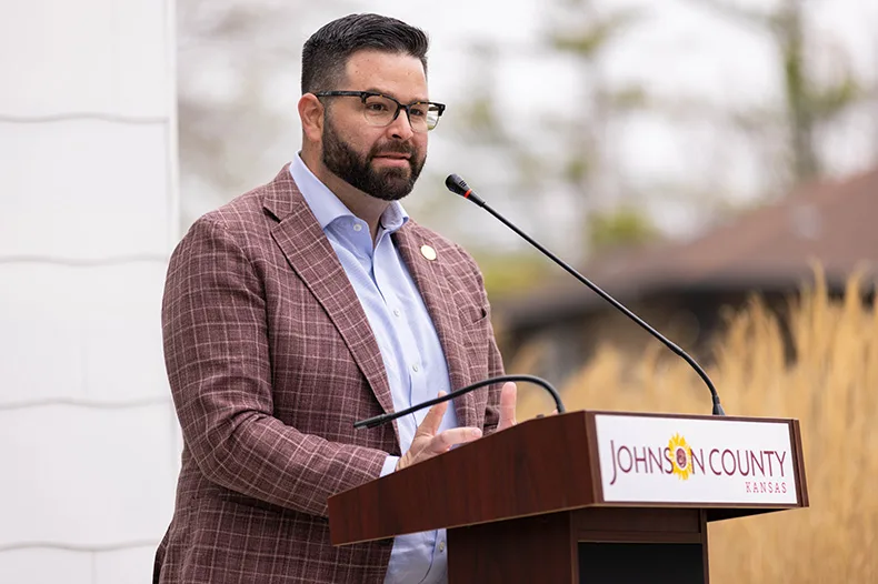 Johnson County Commission Chairman Mike Kelly speaks during the ceremony celebrating new rental units for those experiencing homelessness in Olathe.