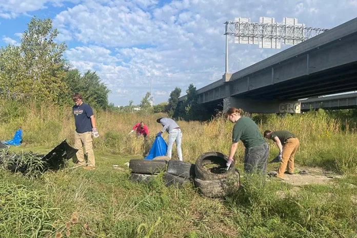 Volunteers lend a hand during Renewing the Blue trash clean-up near the Blue River.