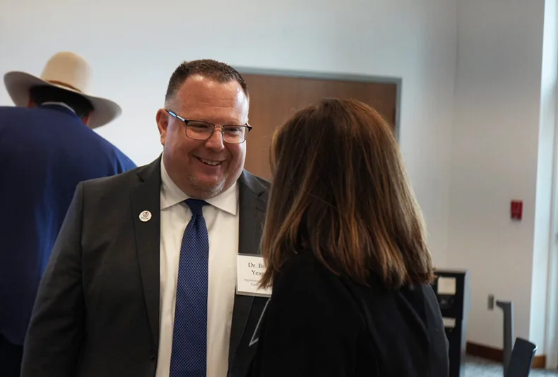 Superintendent Brent Yeager (left) addressed teacher retention in his speech at MidAmerica Nazarene's annual educators luncheon.