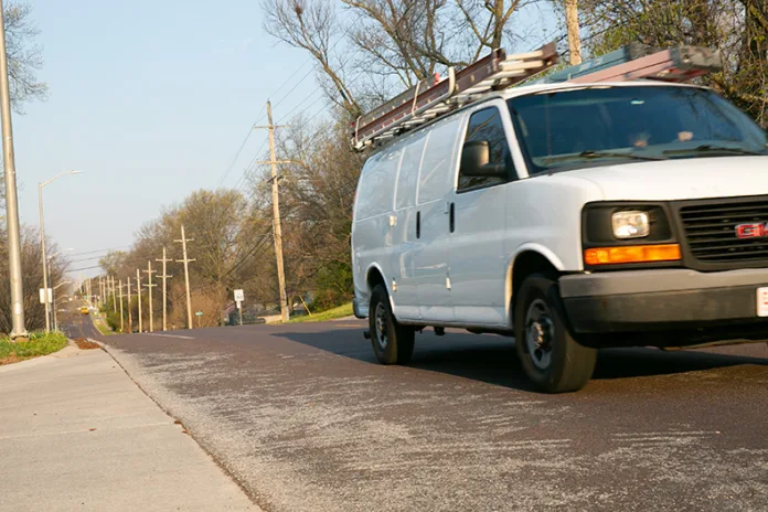 A van drives eastbound on 87th Street in Overland Park near the Goodman Street intersection. Photo credit Juliana Garcia.