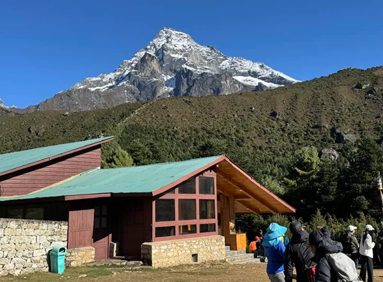 A house with a mountain in the background.