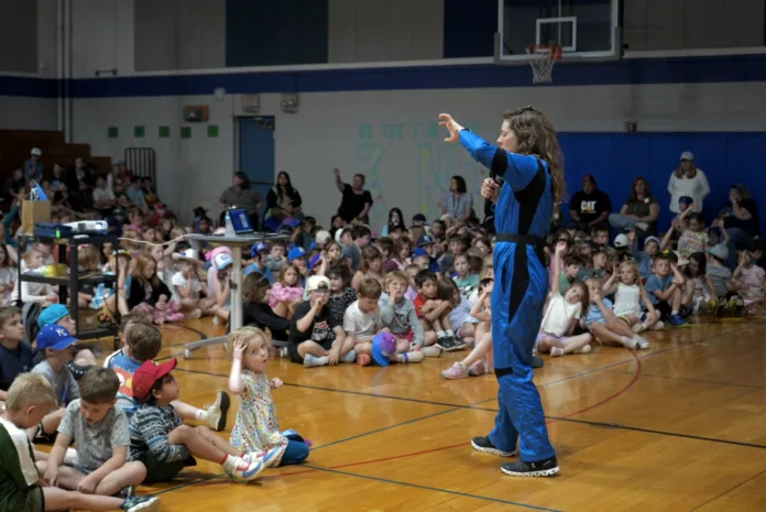 Stiles holds up a “bear claw” to help silence students before continuing her presentation. Teachers at Belinder Elementary use the “bear claw,” representing the school mascot, as a tool to help quiet the children down.