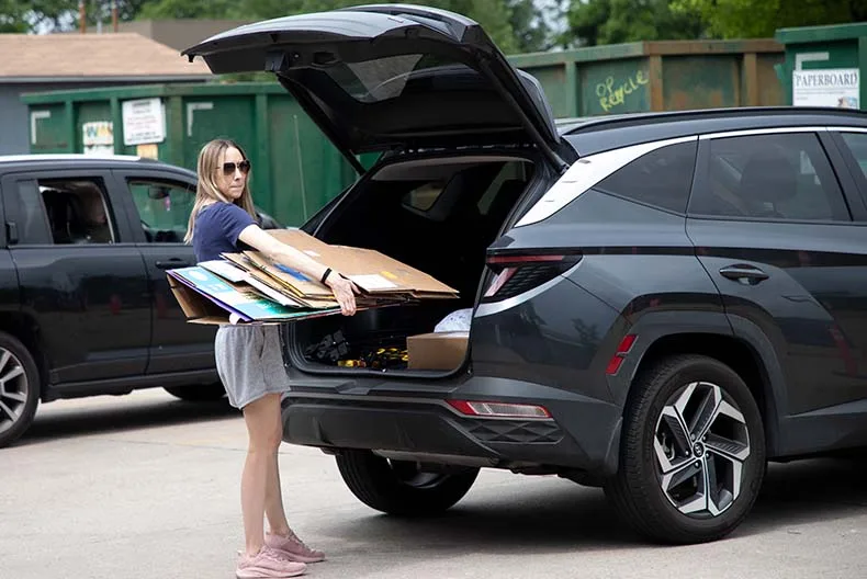 A recycling center patron drops off cardboard on Thursday afternoon.