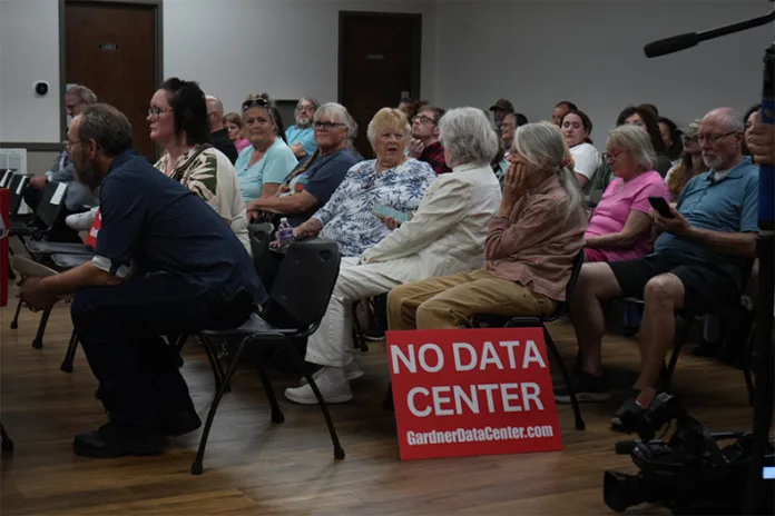 Residents chat ahead of the Edgerton Planning Commission meeting Tuesday night. By the time the meeting started, roughly 75 people filled the room.