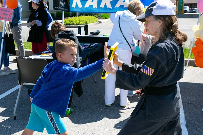 Once parade goers made their way to Corinth Square, the festivities continued. Above, a young boy practices karate. Photo credit Juliana Garcia. 