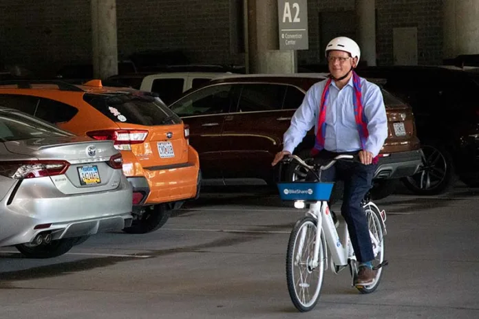 Mayor Curt Skoog rides an e-bike from the new bike share program in Overland Park.