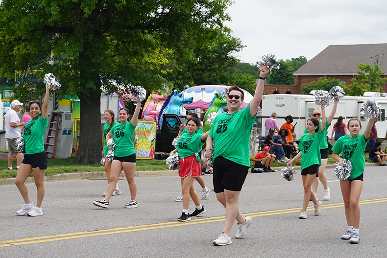 People wave to the crowd at Old Shawnee Days Parade. Photo credit Andrew Gaug.