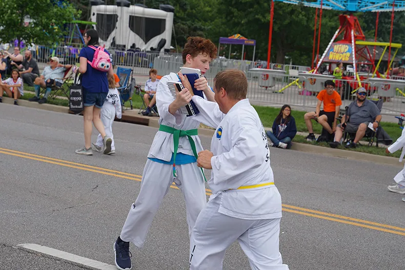 People perform karate at the Old Shawnee Days Parade. Photo credit Andrew Gaug.