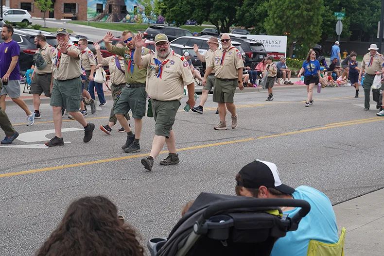 Marchers in the Old Shawnee Days Parade wave to the crowd. Photo credit Andrew Gaug.