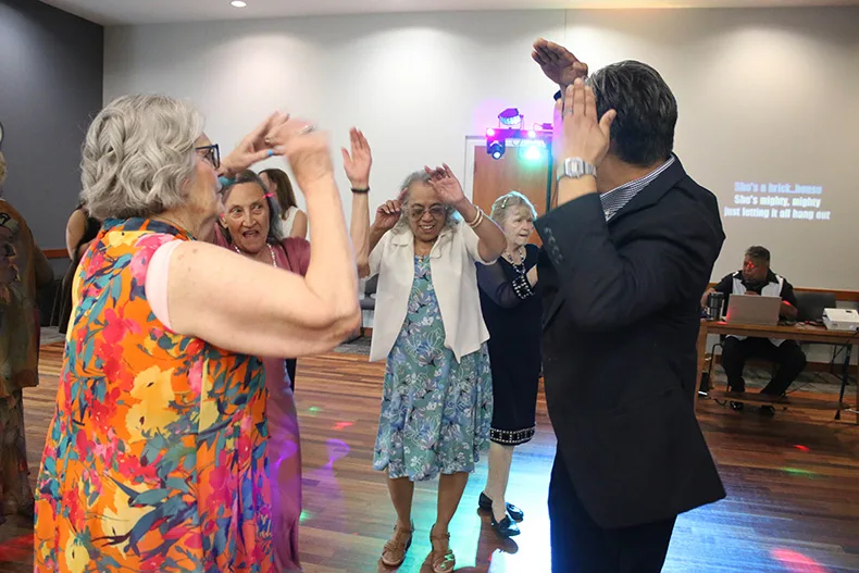 From left, Morningside Place residents Elaine Nelson and Blanche Kearny dance with Irene Mendoza and Laci Sarmiento at the senior prom at Matt Ross Community Center on June 17.