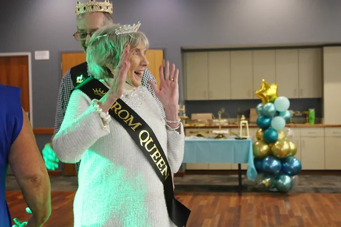 Betty Snavely shows her joy at being named prom queen for Trustwell Living of Overland Park during the senior prom at Matt Ross Community Center.