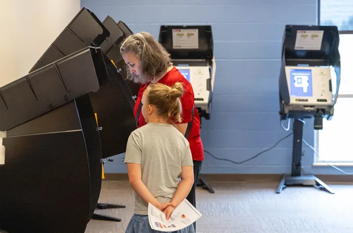 An early voter hits the polls on Thursday, July 30, at Hilltop Conference Center in Overland Park.