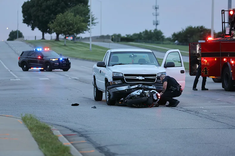 Firefighters lift pickup truck off a pinned motorcyclist in Lenexa