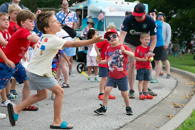Dozens of kids gathered to catch candy falling from the sky — which was actually thrown from a fire truck ladder by Mayor Eric Mikkelson. Photo credit Juliana Garcia. 