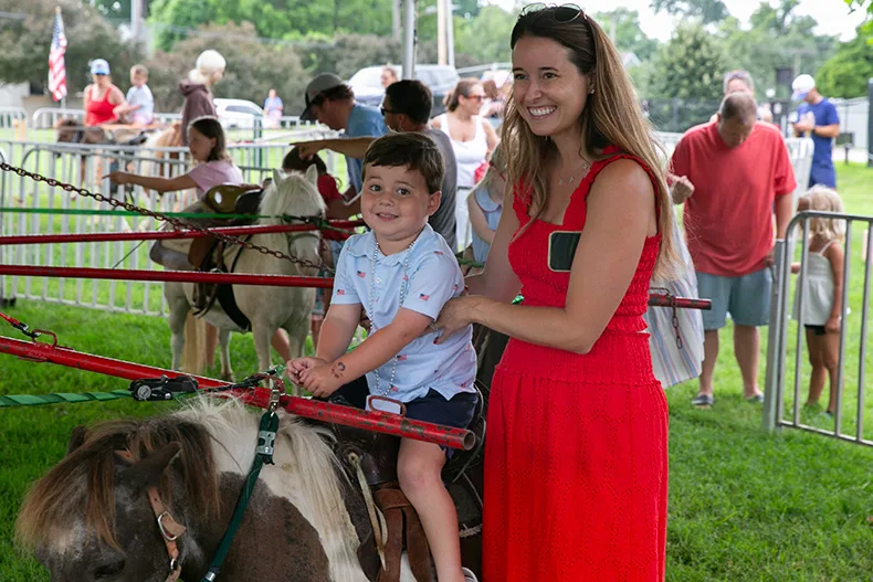 Pony rides are one of the many offerings at VillageFest, which this mom and son enjoyed. Photo credit Juliana Garcia. 