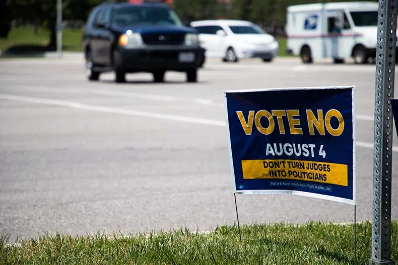 A yard sign on Metcalf Avenue urging voters to reject a constitutional amendment that would change the Kansas Supreme Court bench into an elected body.