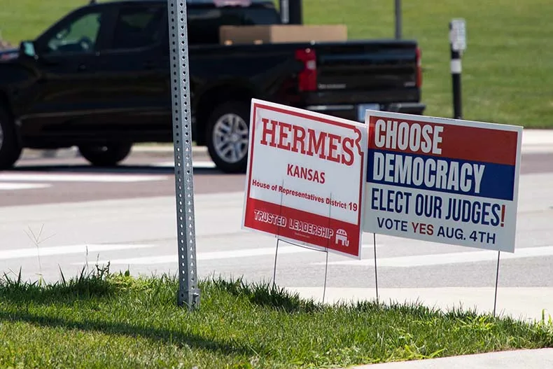A yard sign placed in a median on Metcalf Avenue urging voters to support a constitutional amendment to change the Kansas Supreme Court bench into an elected body.