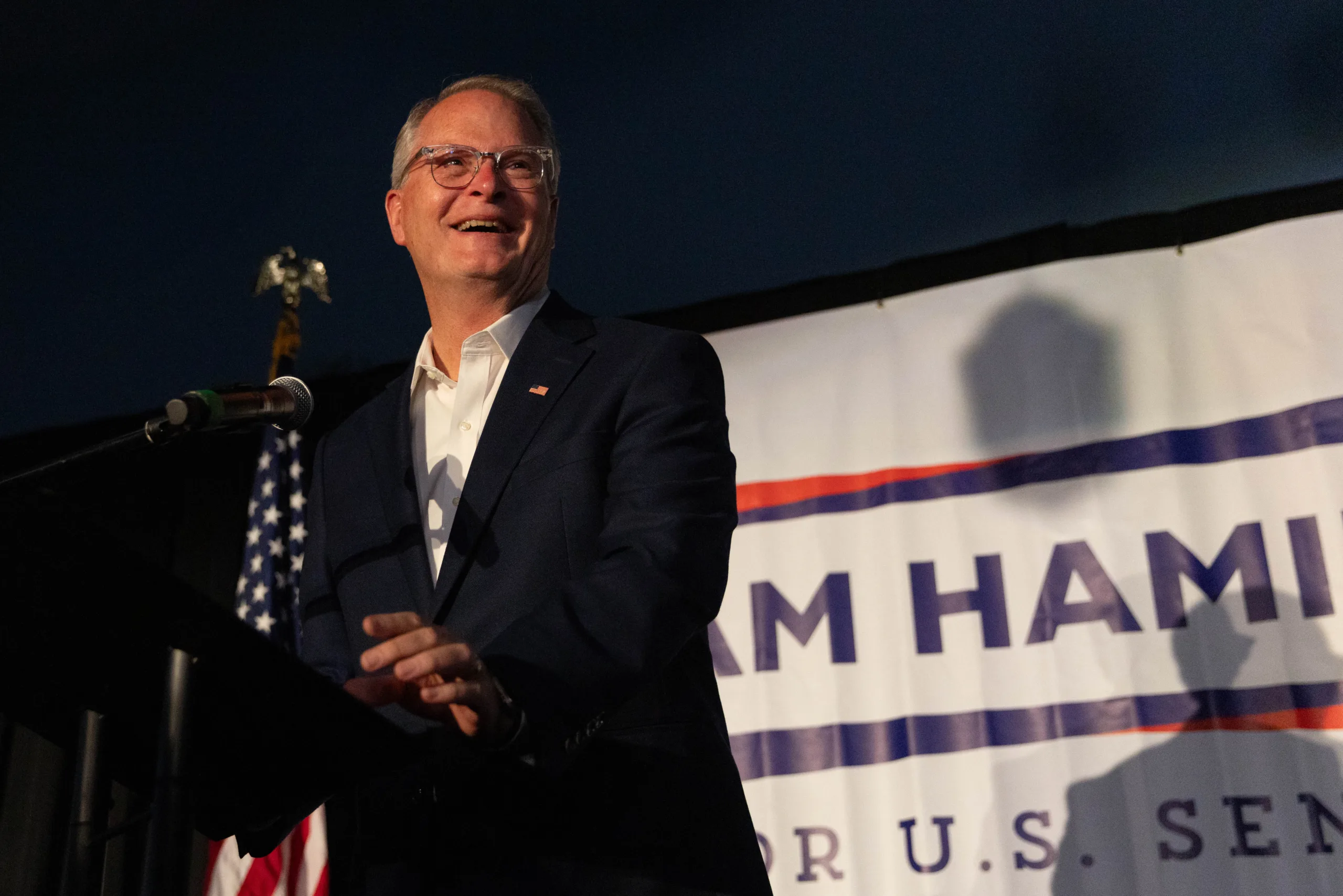 Adam Hamilton greets guests at his watch party on Tuesday night.