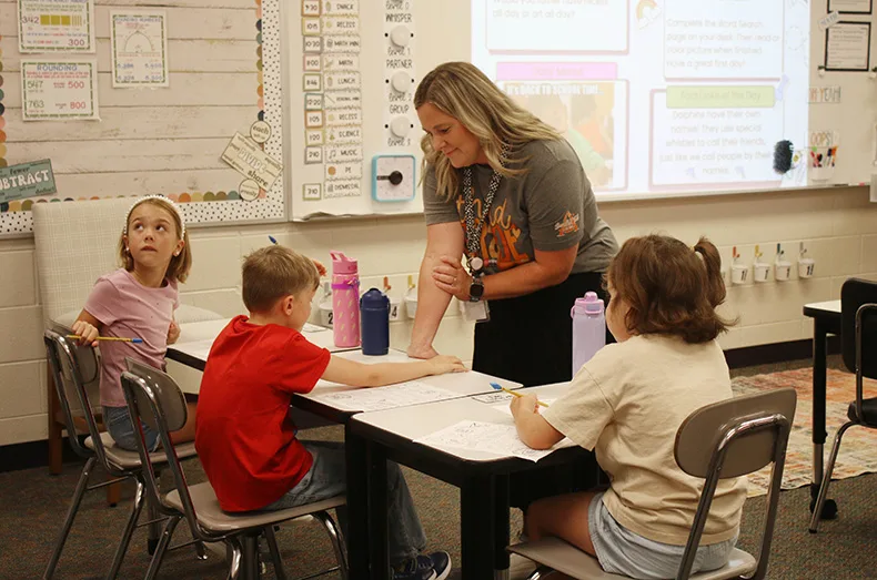 Third-graders talk with their teacher at Prairie Creek Elementary School.