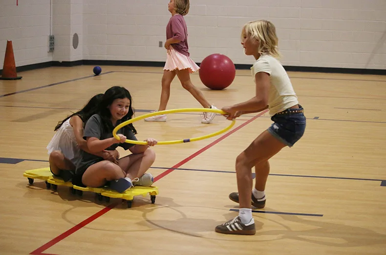 Fifth-graders at Prairie Creek Elementary School play during gym class on the first day of school.
