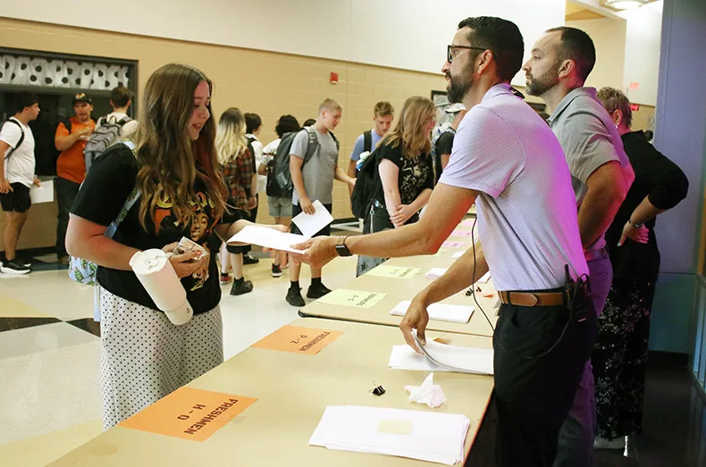 A students receives her schedule on the first day of school at Spring Hill High School.