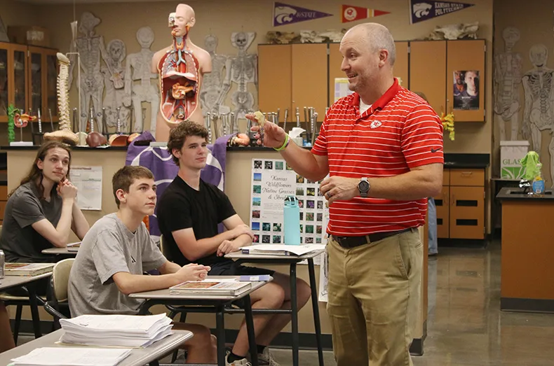 Students listen to their science teacher on the first day of school at Spring Hill High School.