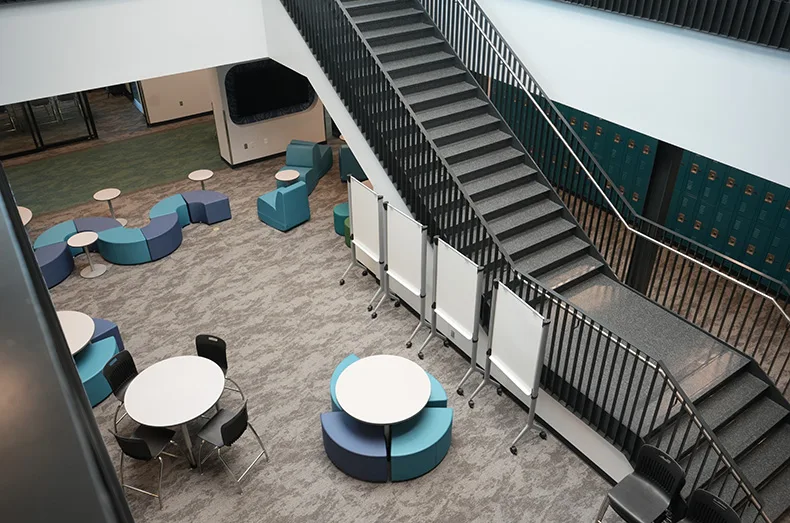 The three pods for each grade have a first and second floor, with large doors that can easily close off the pods for safety. The central area for each pod includes a common work space for students throughout the day.