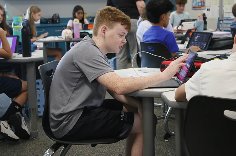 A student uses a tablet during class at Woodland Springs Middle School.