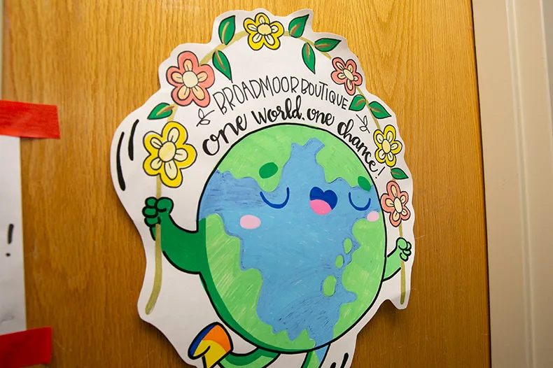 A sign on the door of Broadmoor Boutique reads "One world, one chance." In a four to six month period in the past year, the Boutique saved more than 2,000 items from the landfill. Photo credit Juliana Garcia. 