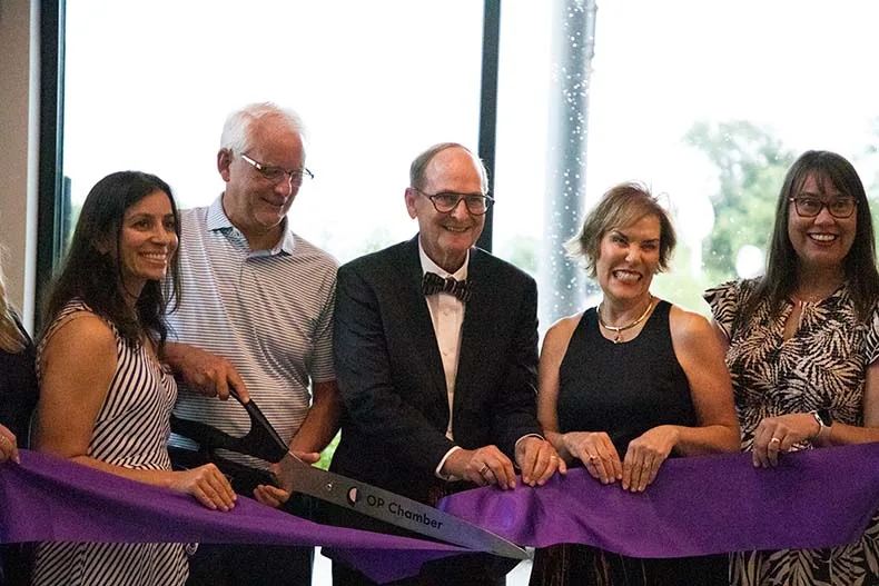 Hal and Julie Hanson stand with city officials to cut the ribbon to officially mark the unveiling of the "Growing Kindness" sculpture at the Overland Park Arboretum, dedicated in memory of their son Jeff.