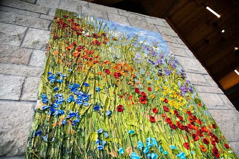 In addition to the "Growing Kindness" sculpture near the entrance to the Overland Park Arboretum, the LongHouse also has a painting from Jeff Hanson Art that features the textured acrylic painting style for which the artist was known.